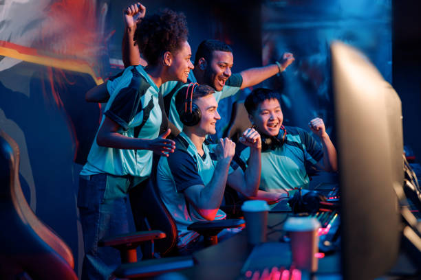 team of professional cybersport gamers celebrating success in gaming club - gamer imagens e fotografias de stock