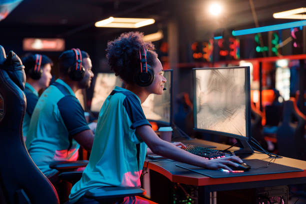 istock Team playing esports game on computer in internet club 1354761880