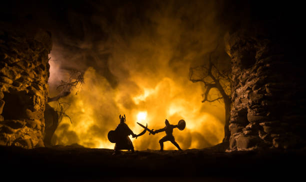 istock Medieval battle scene with cavalry and infantry. Silhouettes of figures as separate objects, fight between warriors on dark toned foggy background with medieval castle. 1354764474
