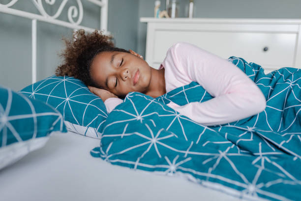 istock A little girl is sleeping in bed 1354765889