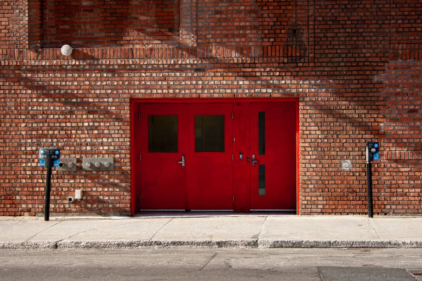 istock Brick wall with bright red door 1354770765