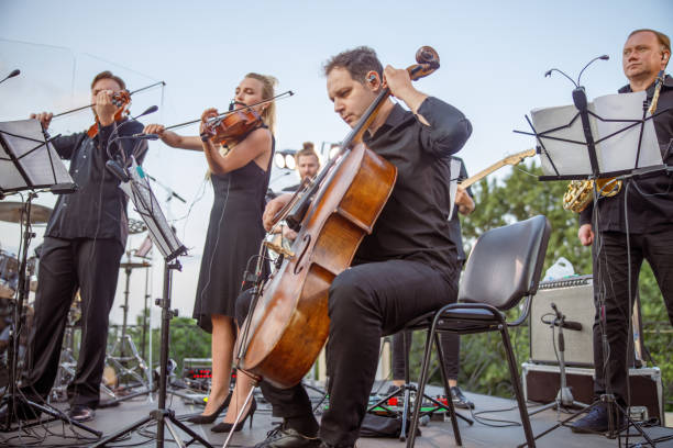 istock Musical ensemble playing classical music on outdoor stage 1354772439
