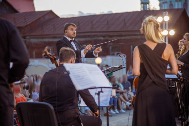 istock Conductor directing orchestra performance on the street 1354772543