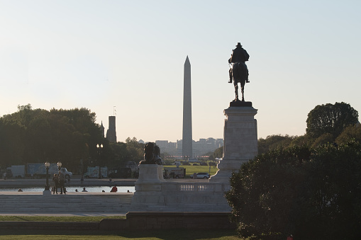 The long grassy National Mall is home to iconic monuments. At the eastern end is the domed U.S. Capitol, and the White House is to the north.