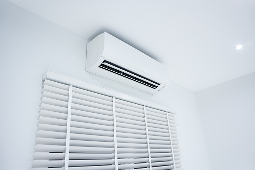 Air conditioner (ac) wall mount or indoor unit of split system for control climate, temperature and humidity in room of home building. Include adjusting vertical or venetian blinds for adjust, close or open to allow natural light, sunlight or sunshine to inside room.