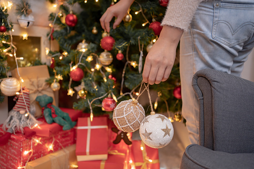 Woman with gift and present for Christmas and New Year party at home.