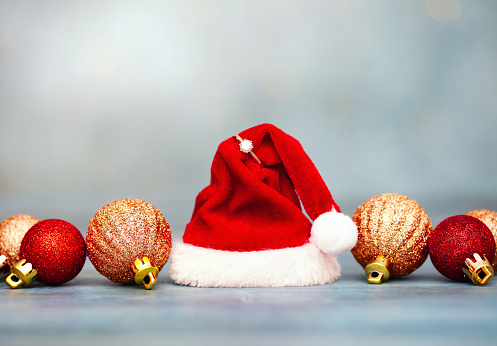 Little Christmas tree and Santa Claus red hat isolated on white background. Christmas background.