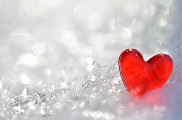 istock Red heart on shiny snow 1354791576