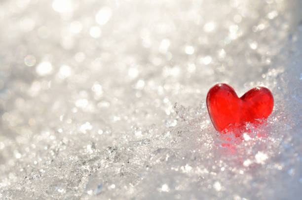 istock Red heart on shiny snow 1354791590