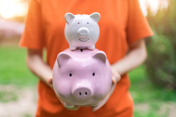 istock Holding Piggy Bank 1354793947