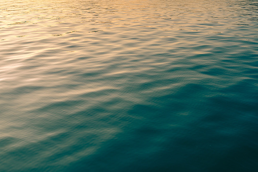 This October 2021 dusk photo shows the teal waters of Akaroa Harbour in Ōtautahi Christchurch, Aotearoa New Zealand.