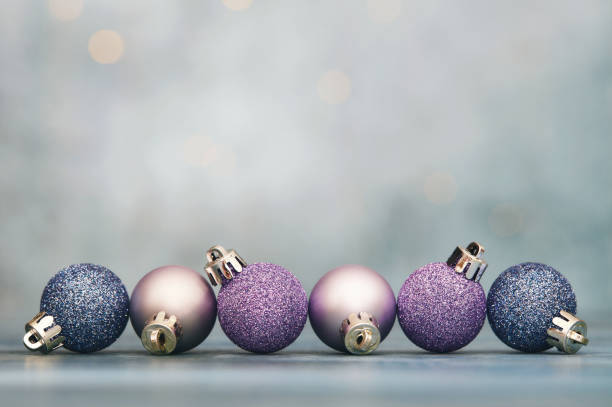 Christmas background with glittery purple and blue Christmas ornaments and copy space for text Christmas background with glittery purple and blue Christmas ornaments and copy space for text teal photos stock pictures, royalty-free photos & images