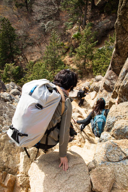 Female hikers descending a steep rocky mountain section