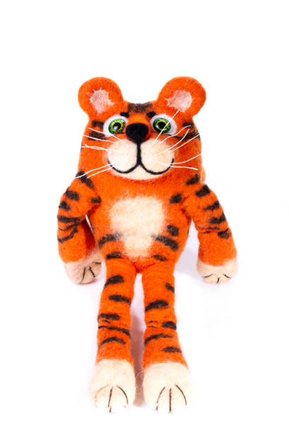 istock Orange tiger cub from natural felted wool on a white background 1354802933