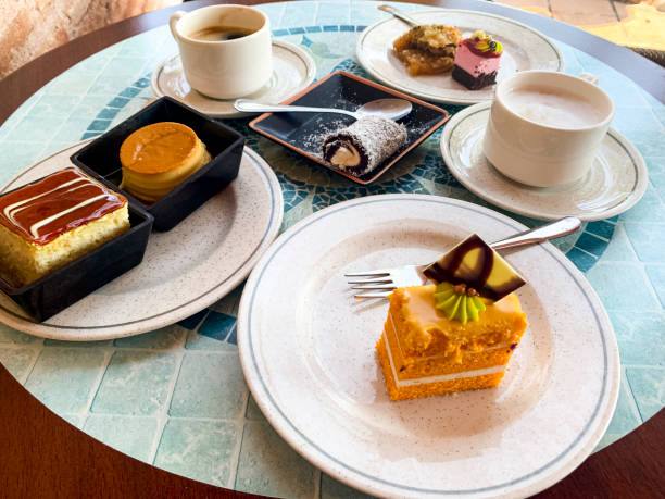 istock Various colored cakes on plates. Sweet desserts. Studio Photo 1354803024