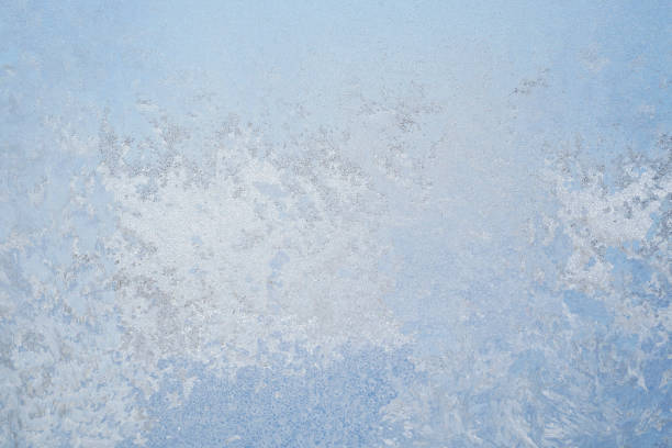 istock Ice pattern on winter glass. Frozen window, abstract blue background. 1354805157