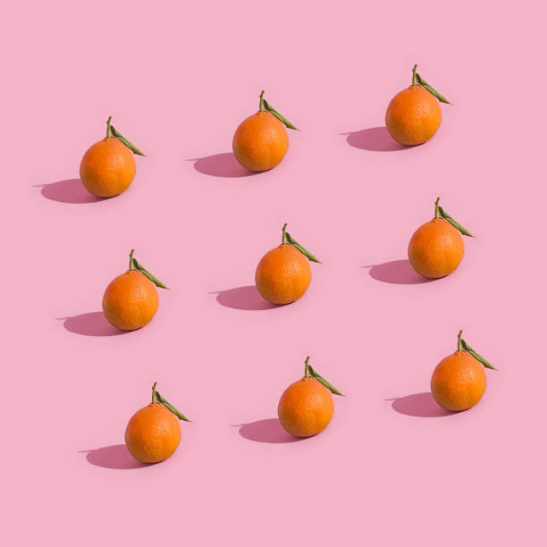 istock Fruit minimalistic pattern of fresh tangerine on pink background 1354806267