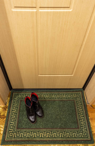 istock Women's shoes on a rug 1354806384
