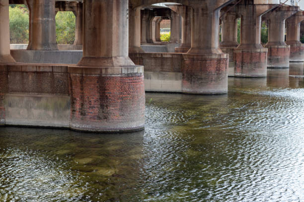 istock Thick concrete bridge piers in the river 1354807063