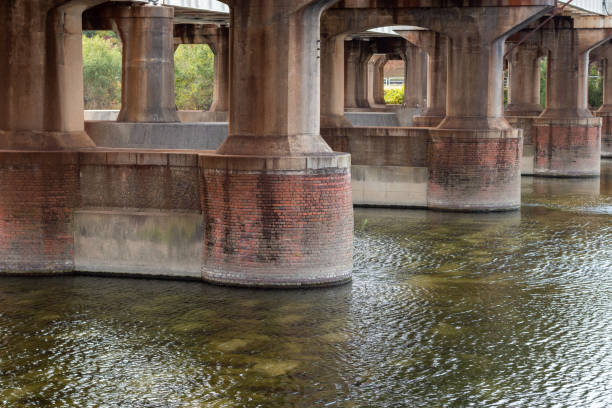 istock Thick concrete bridge piers in the river 1354807106