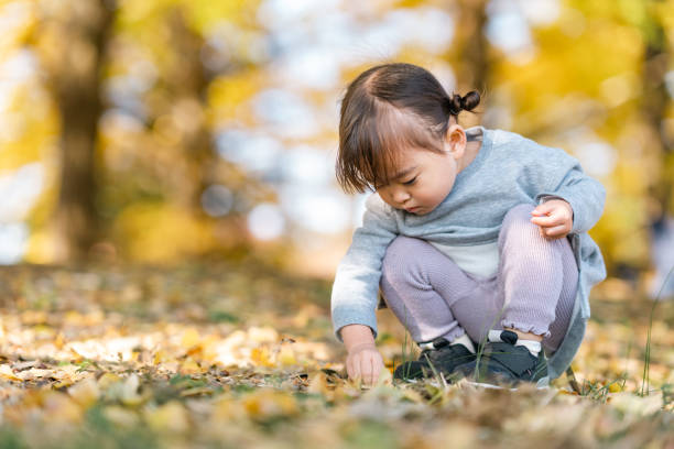istock Cute small girl playing in nature 1354807153