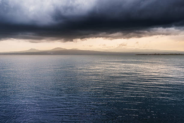 Atmospheric and mood landscape in stormy weather with strong wind on Lake Sevan at sunset.