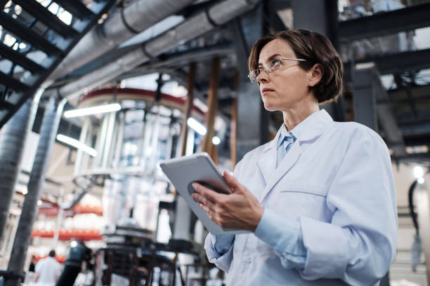 istock Female worker using tablet at the factory 1354814380