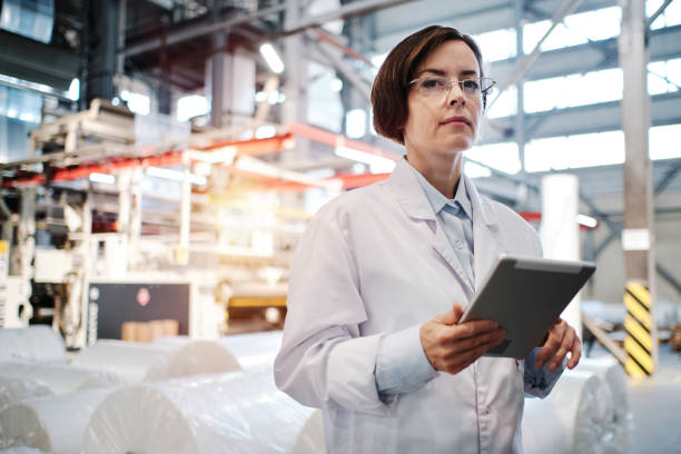 istock Female worker using tablet at the factory 1354814892