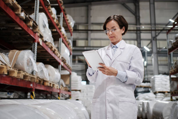 istock Female worker using tablet at the factory 1354814893