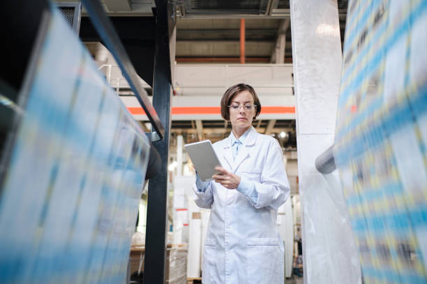 istock Female worker using tablet at the factory 1354814897