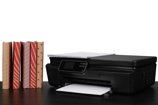 istock Working table with printer and stacked books on white abckground 1354815100