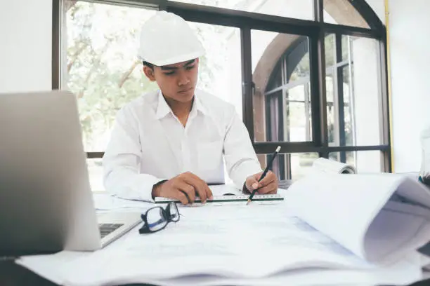 Photo of Architect or engineer working in office