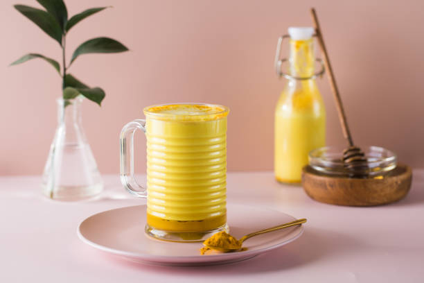 Latte turmeric on a pink background. Moon milk for better sleep. Copy space.
