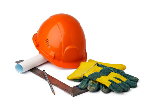 istock Safety hardhat and blueprints isolated on white background 1354818026