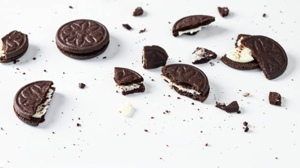 istock Crushed chocolate cookies with vanilla cream filling on white background. 1354820224