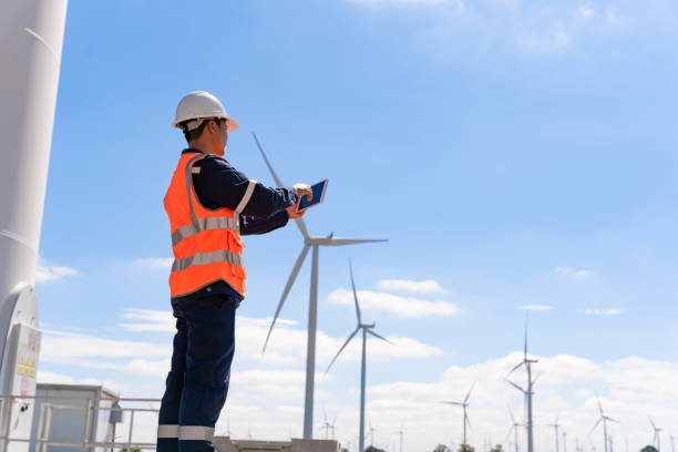 istock Engineer walk to check wind power plants with check performance. Wind turbines are an alternative electricity source to be sustainable resources in the future. Clean energy concept saves the world 1354820425