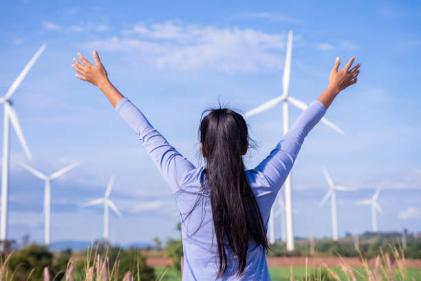 istock Wind turbines are an alternative electricity source to be sustainable resources in the future. People in the community with wind generators turbines. Clean energy concept saves the world 1354820441