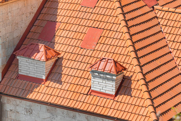 orange roof of a modern house is covered with orange tiles. chimneys and attics in a residential building - roof tile architectural detail architecture and buildings built structure imagens e fotografias de stock