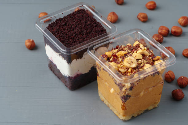 Creamy dessert in a plastic box on gray table