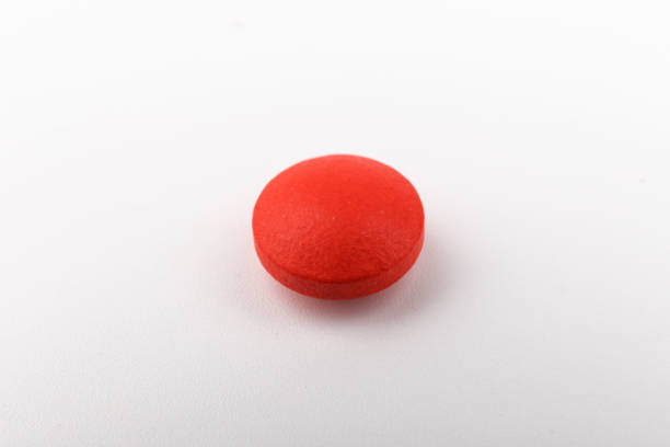 istock Red pills on a white background, isolated. Pharmacy. Treatment. 1354823960