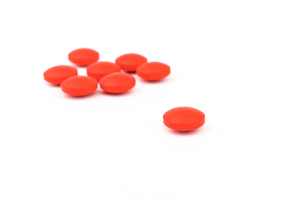 istock Red pills on a white background, isolated. Pharmacy. Treatment. 1354823963