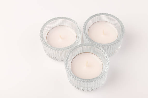 istock Tea candles in a glass candlestick, isolated on white. Space for text 1354824219