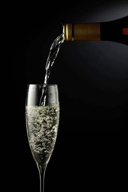 istock Sparkling wine is poured from a bottle into a glass. 1354824937