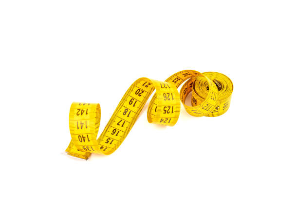 istock Yellow measuring tape spiral, isolated on white background. 1354824952