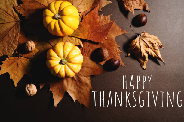istock Happy Thanksgiving Day with pumpkin and maple leaves 1354825009