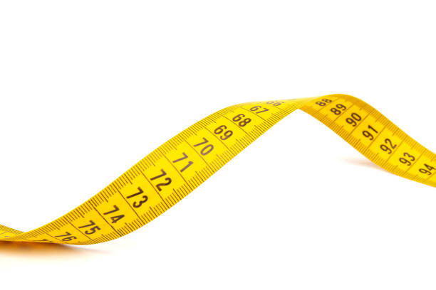 istock Yellow measuring tape spiral, isolated on white background. 1354825042