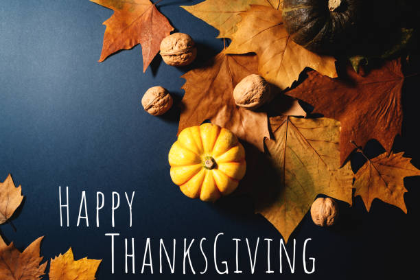 istock Happy Thanksgiving Day with maple leaves, nut and pumpkin on blue background 1354825057