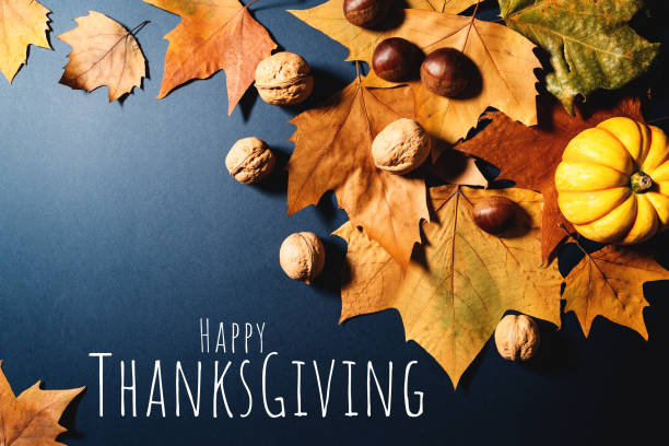 istock Happy Thanksgiving Day with maple leaves, nut and pumpkin on blue background 1354825168