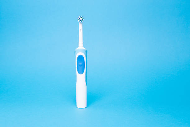 istock Smart electric toothbrush on a blue isolated background 1354825170