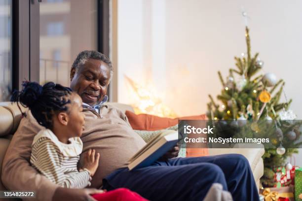 Christmas Night With A Grandfather And A Fairytale Book Stock Photo - Download Image Now